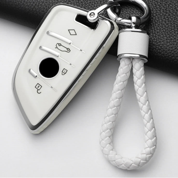 Car key fob with braided white keychain on a gray background